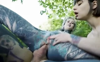 Heavily inked lovers and cutie have anal threesome in the woods